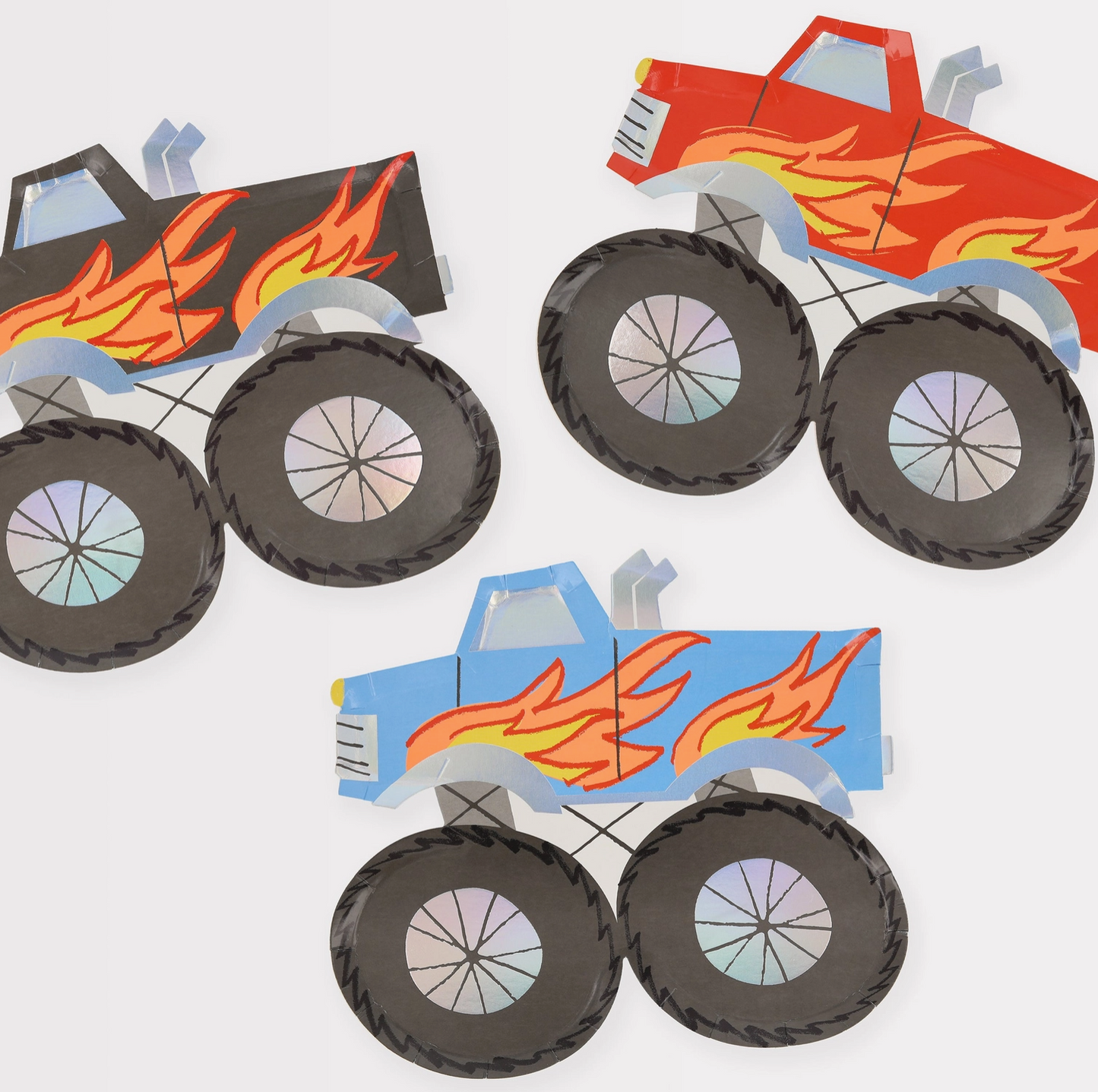 Three paper models of monster trucks with flames on a white background