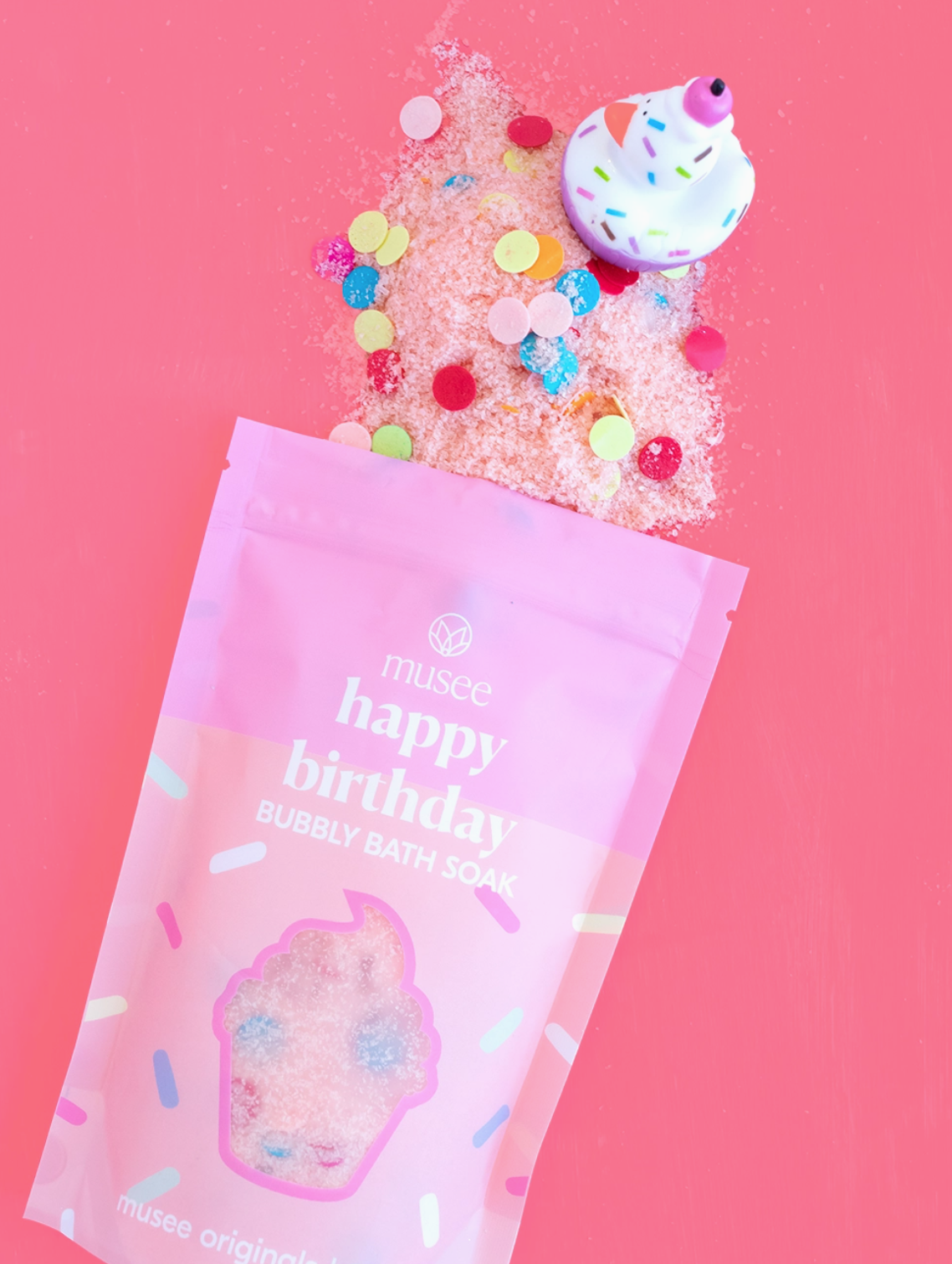 Happy Birthday bubble bath with packaging on a pink background