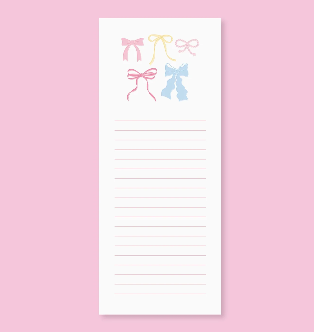 Notepad with colorful bow designs on a pink background