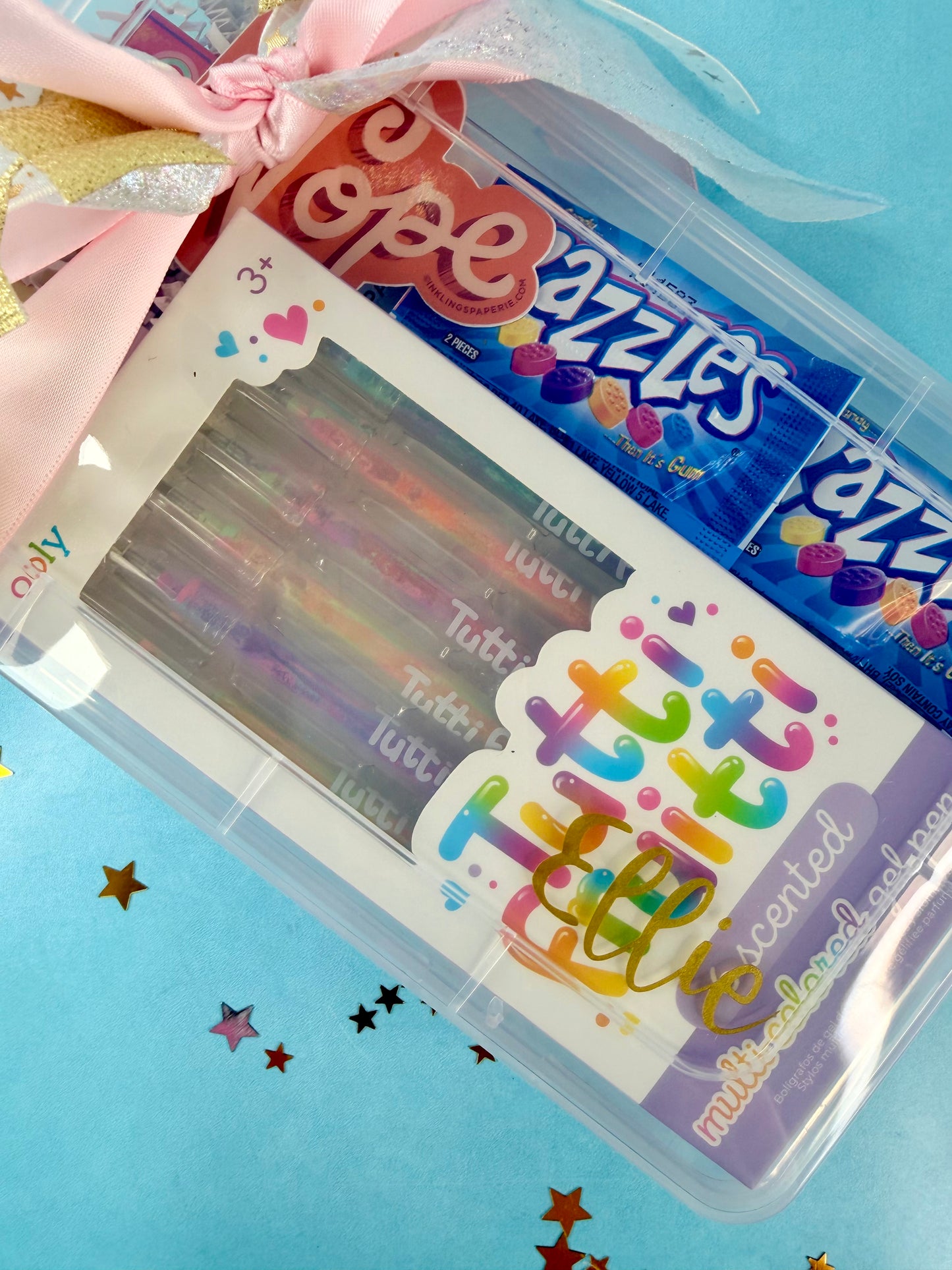 Packaged product with colorful text and a clear lid on a blue background