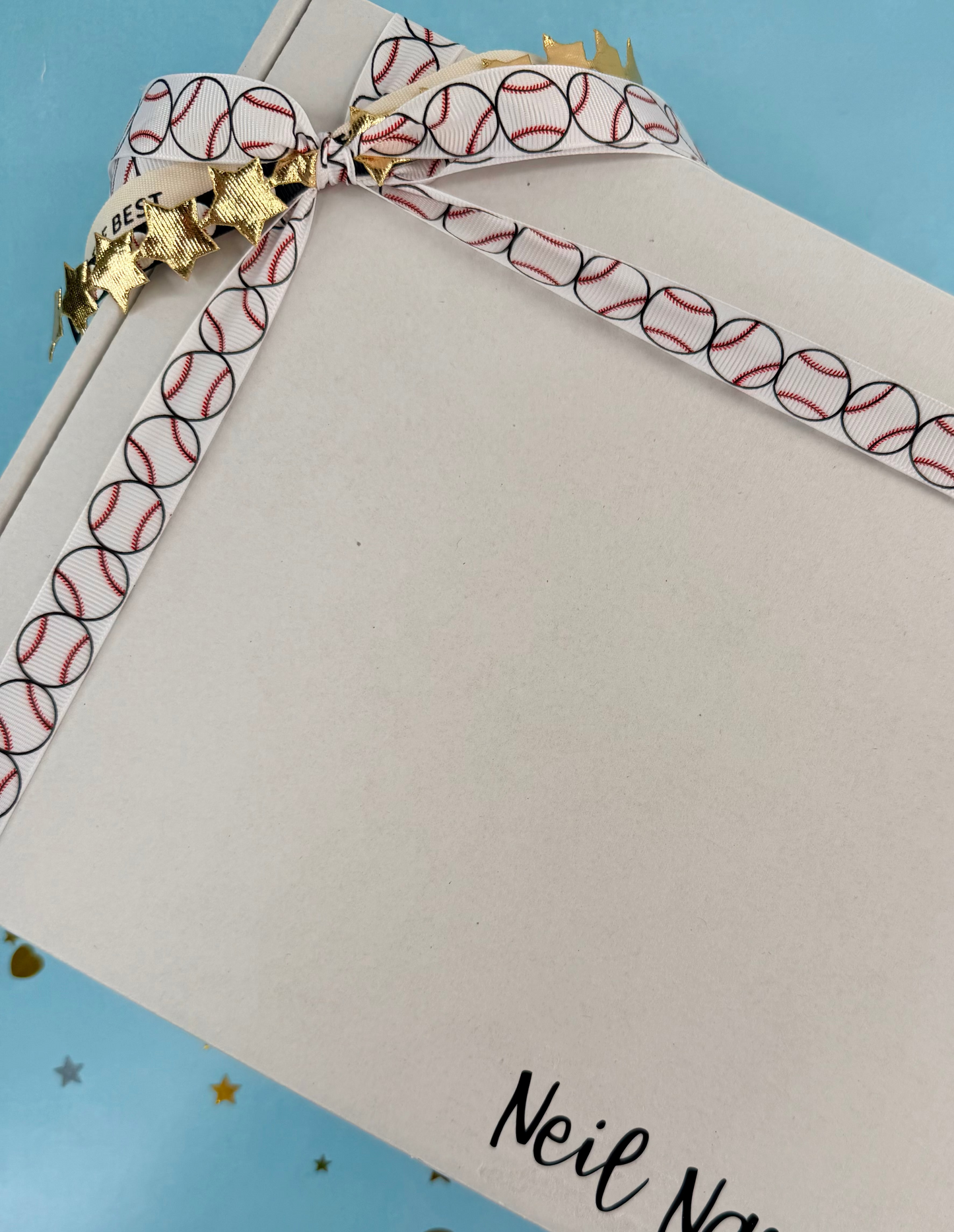 Notebook with a decorative ribbon and 'Neil Narayan' branding on a blue background