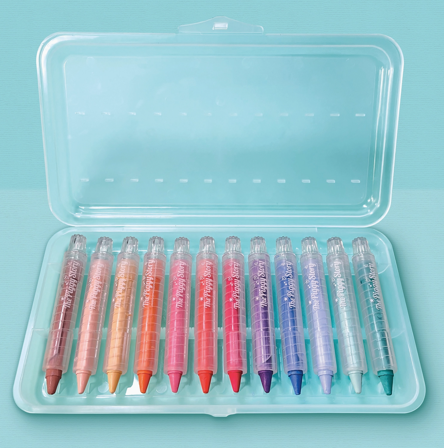 Set of colorful markers in a clear plastic case on a light blue background