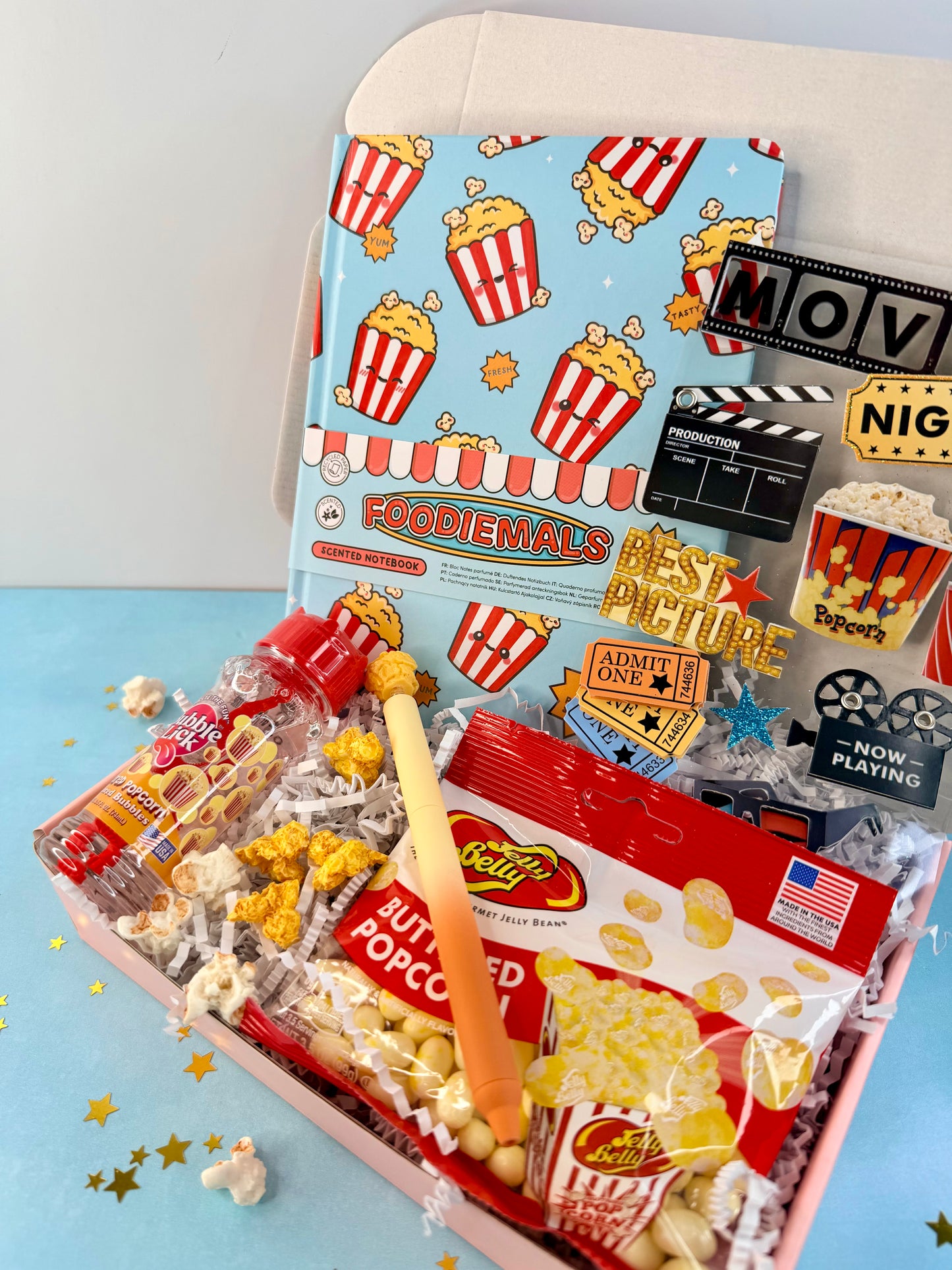 Popcorn movie night gift box for kids and tweens with notebook, pen, stickers, lickable bubbles, and Jelly Belly popcorn candy.