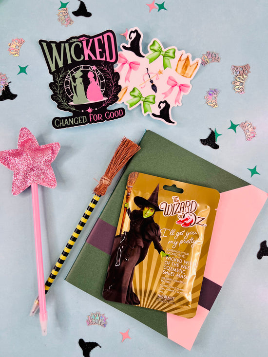 Product packaging with a witch-themed design on a decorative background with stars and brooms.