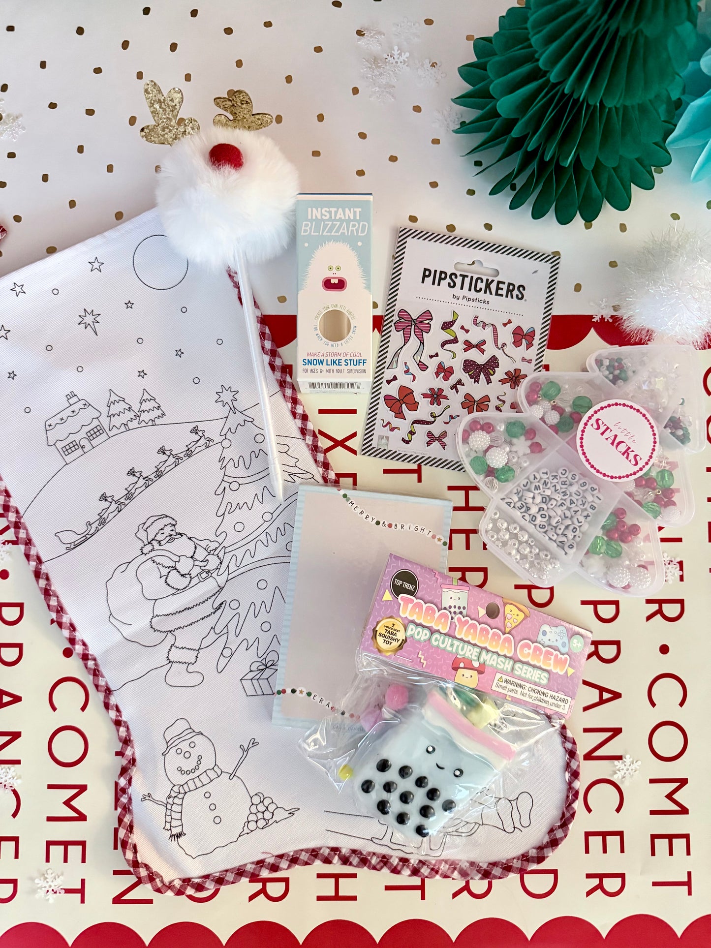 Coloring book with Christmas-themed pages, stickers, and decorative items on a red and white background.