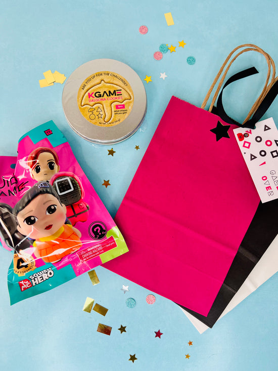 Gift bag with toys and a container on a blue background