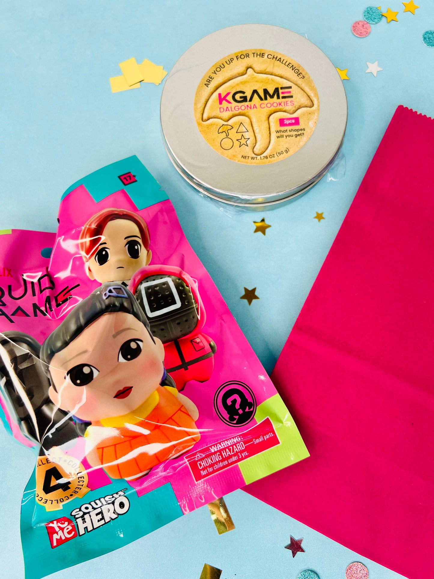Two packages with cartoon characters and a round container labeled 'KGAME' on a colorful background.