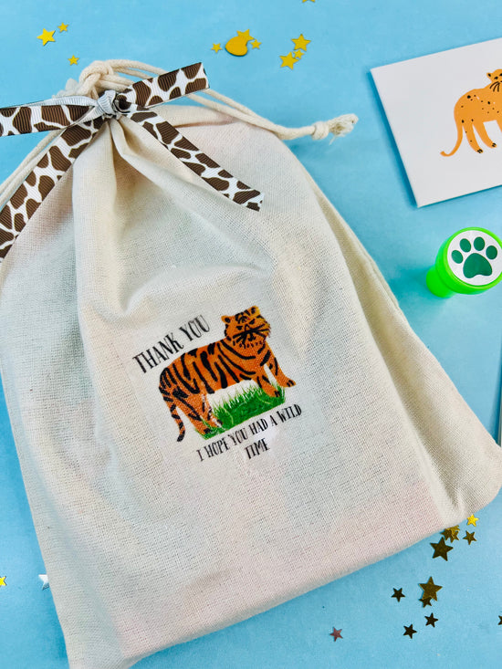 Beige drawstring bag with a tiger design and text on a blue background