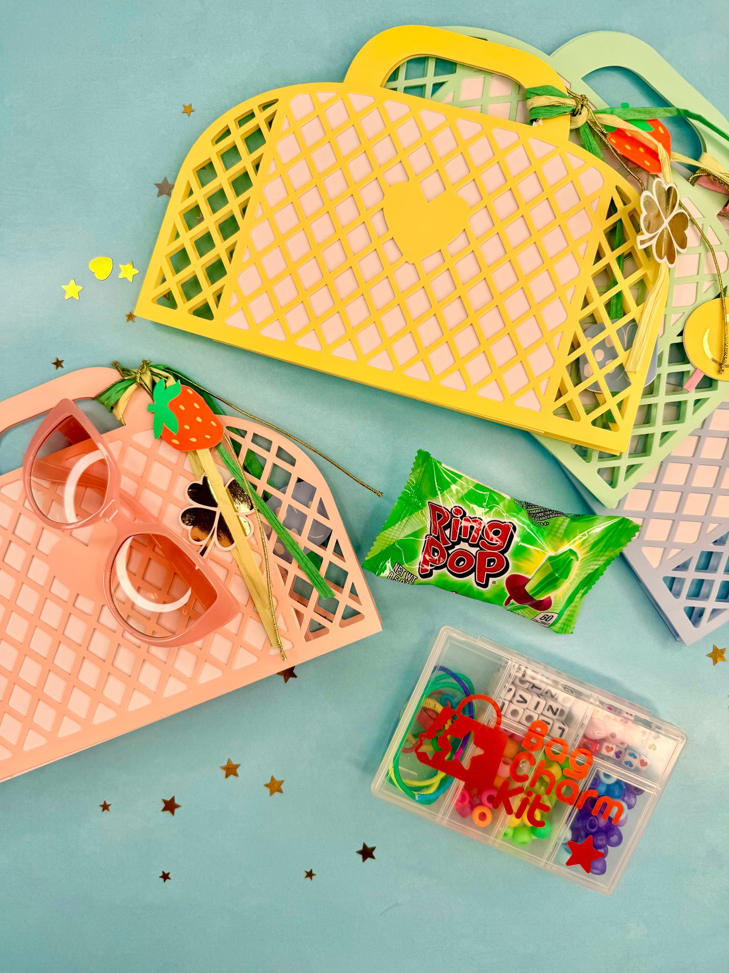 Colorful plastic taco-shaped trays with candy and a small box on a light blue background