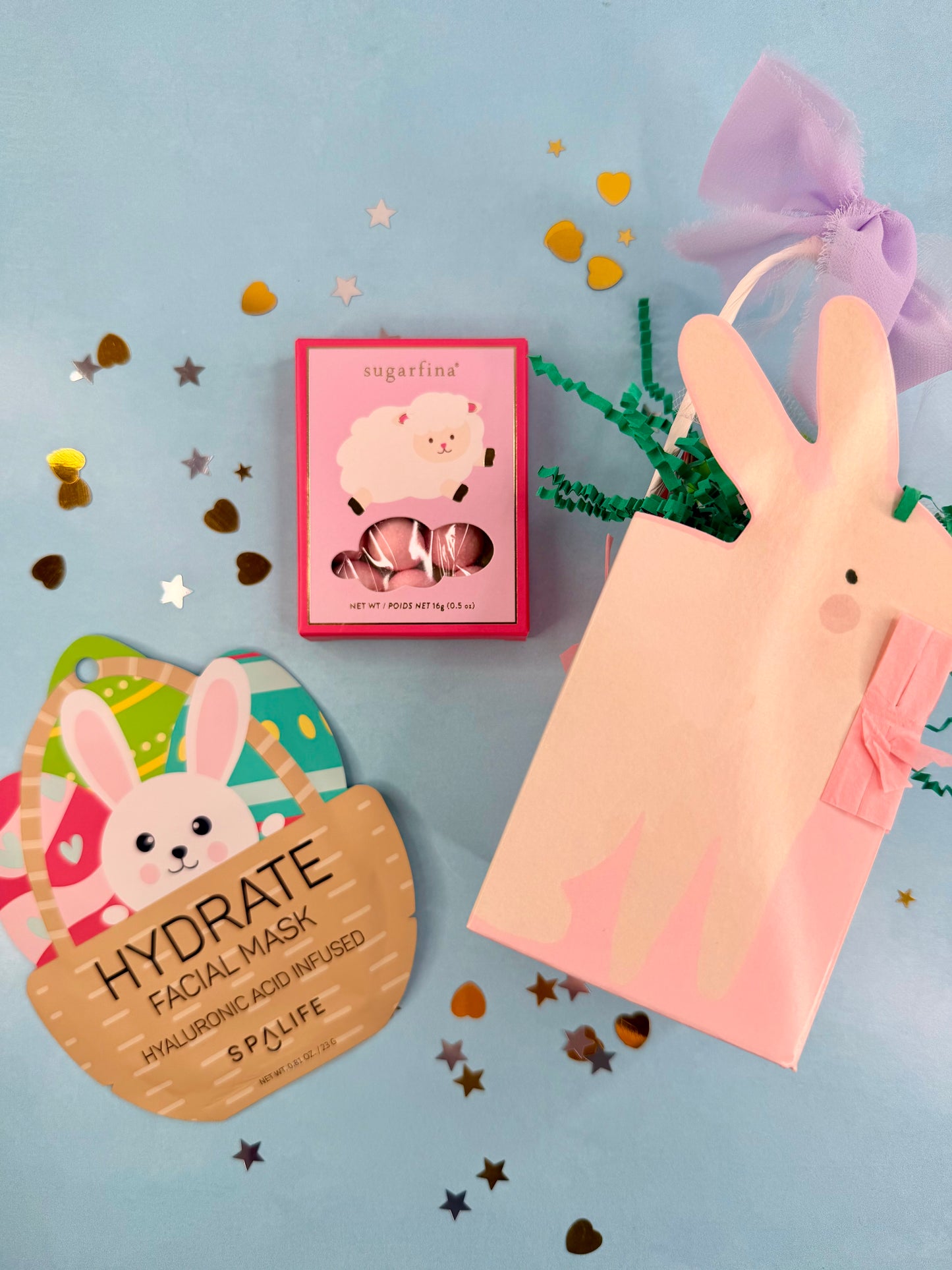 Facial mask packaging with a bunny design and text on a blue background with decorative elements.