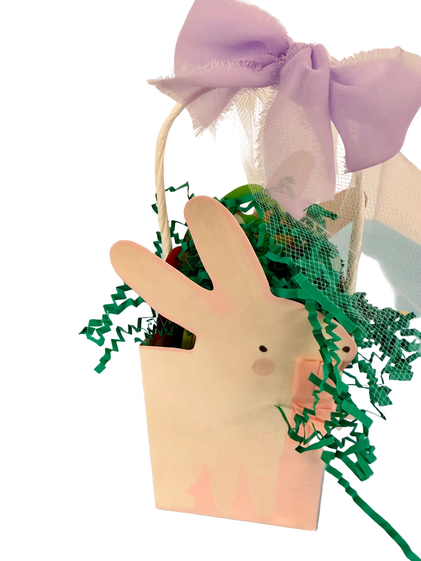 Handmade paper bag with green leaves and a purple bow on a light blue background