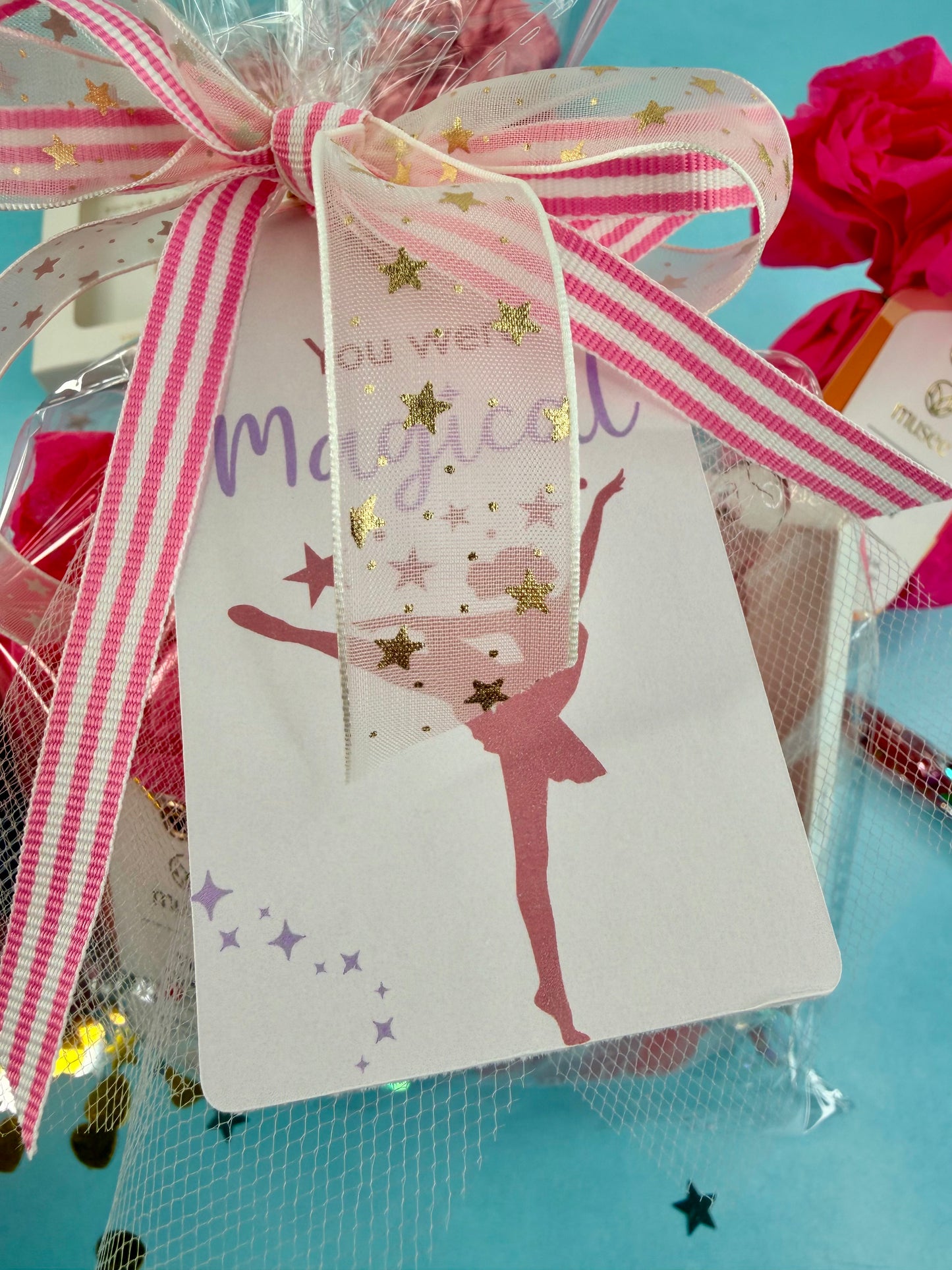 Gift tag with a pink ribbon and a ballerina design on a blue background
