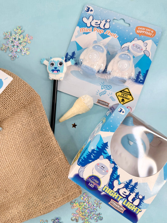 Yeti-themed mini pop jacks and night light on a blue background with decorative elements.