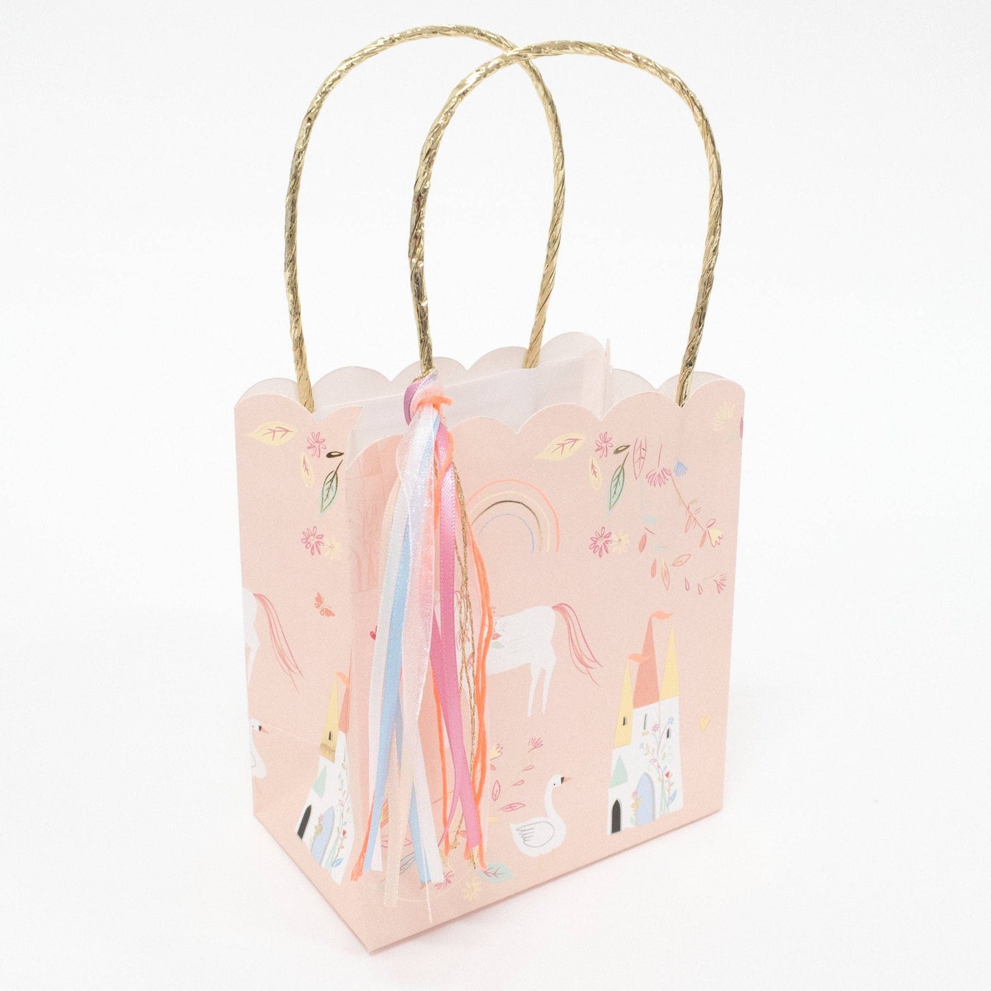 Small pink gift bag with unicorn design and gold handle on a white background