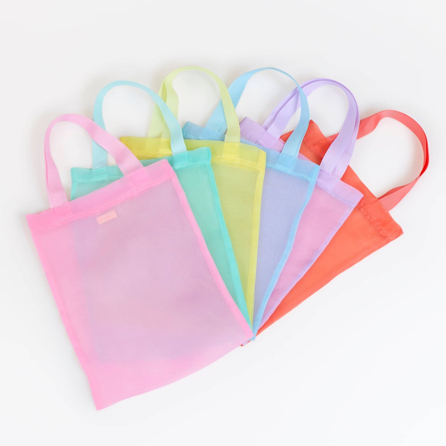 Set of colorful gradient tote bags on a white background
