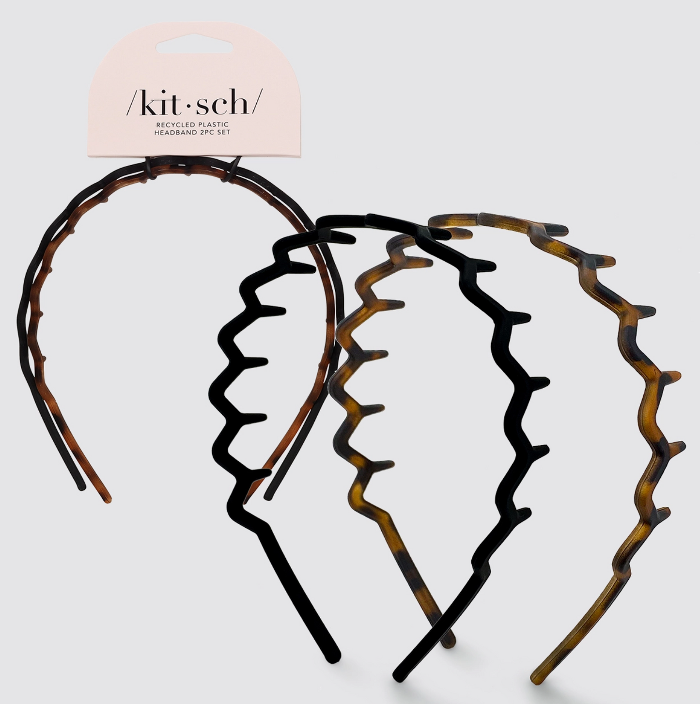 Set of tortoiseshell headbands with 'kitsch' branding on a light gray background