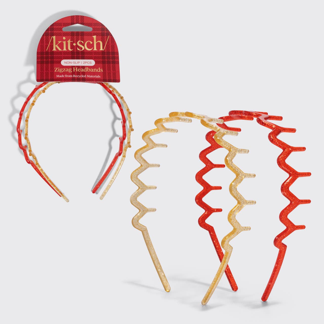 Three Kit-sch Zluzag headbands with a red and gold plaid pattern, shown both on their retail packaging and as a set of three on a light gray background.