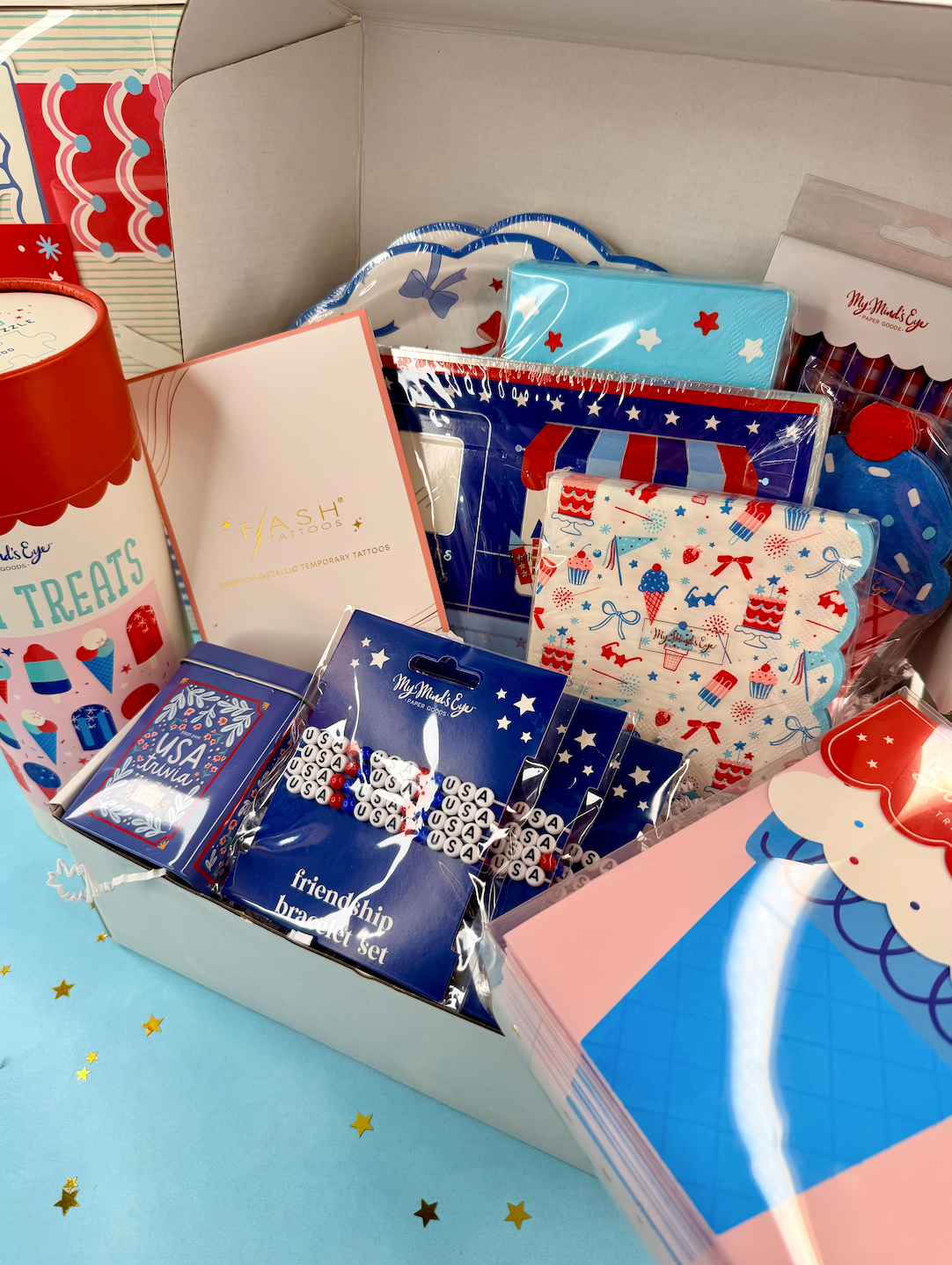 Assorted patriotic-themed items including cards, brooches, and other decorative pieces in a box.