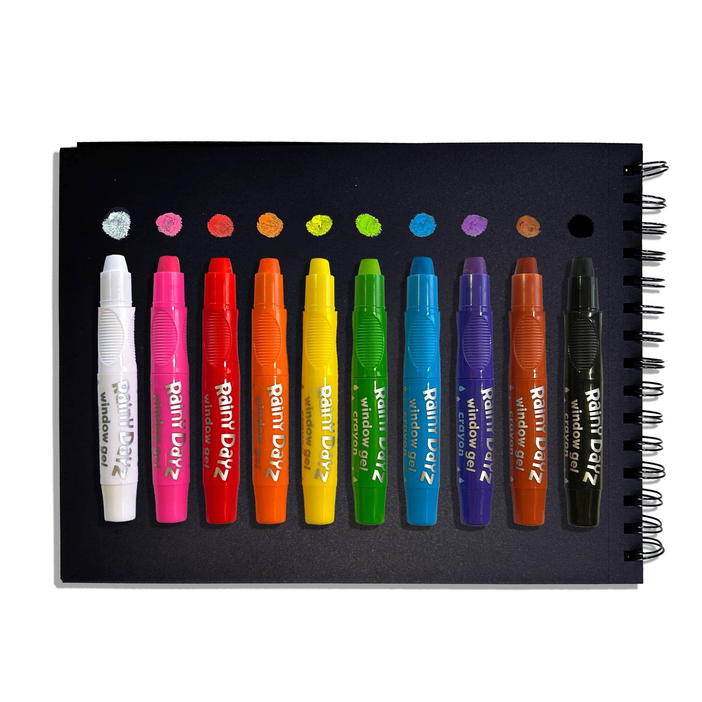 Set of colorful markers on a black notebook with visible brand name.