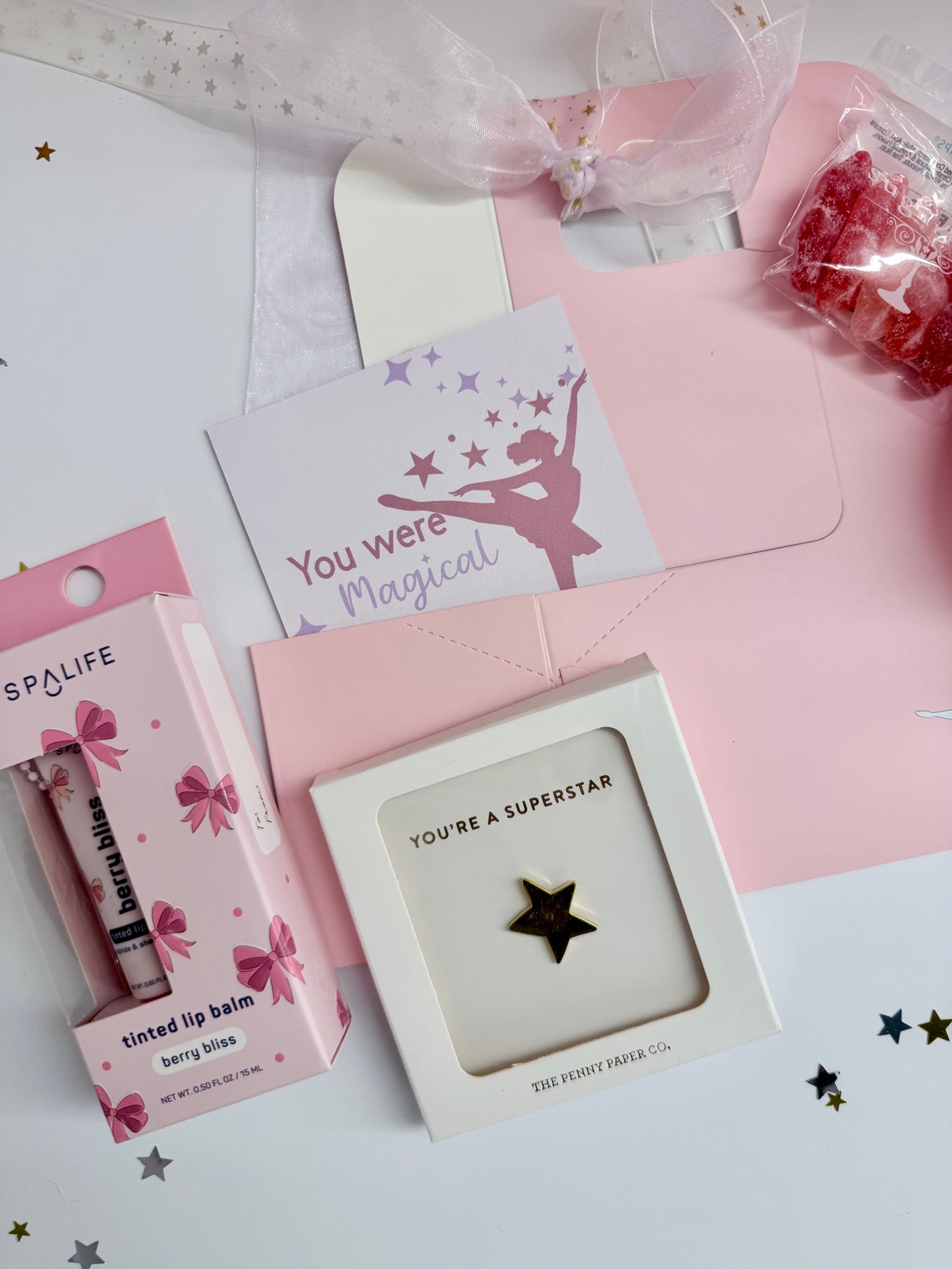 Product display with lip balm, card, and decorative items on a white background