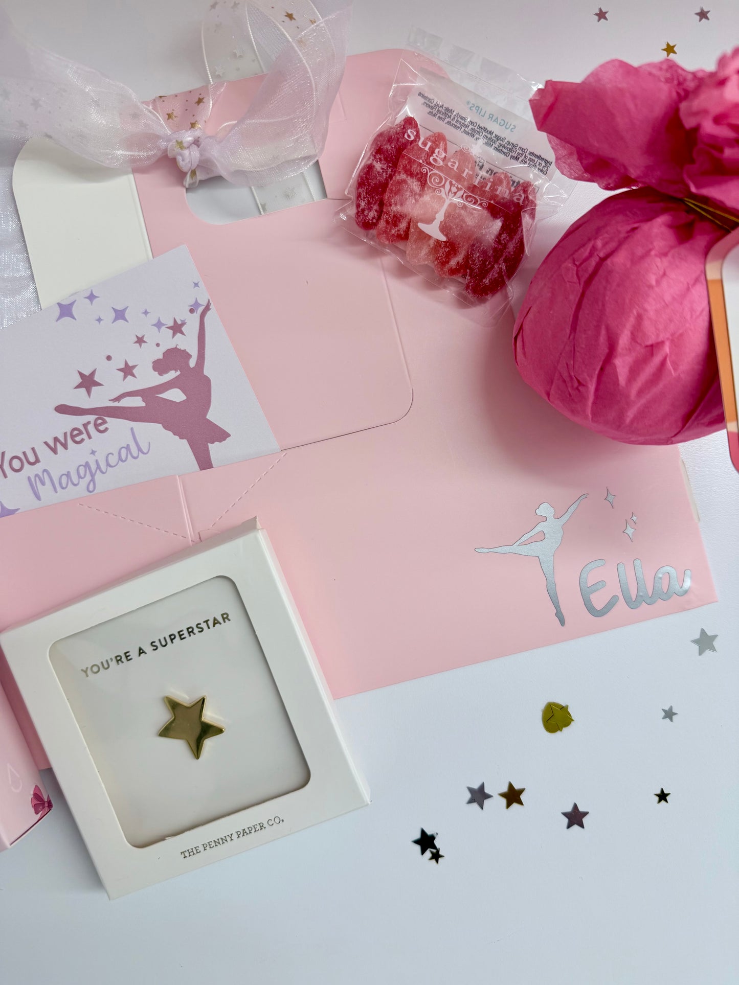Stationery set with 'You Were Magical' card, pink envelope, and decorative items on a light surface.