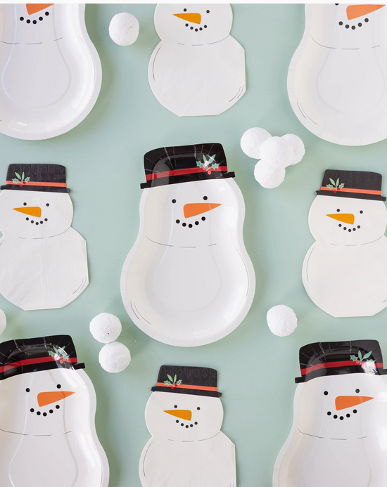 Pattern of snowman-shaped paper plates with hats on a light blue background