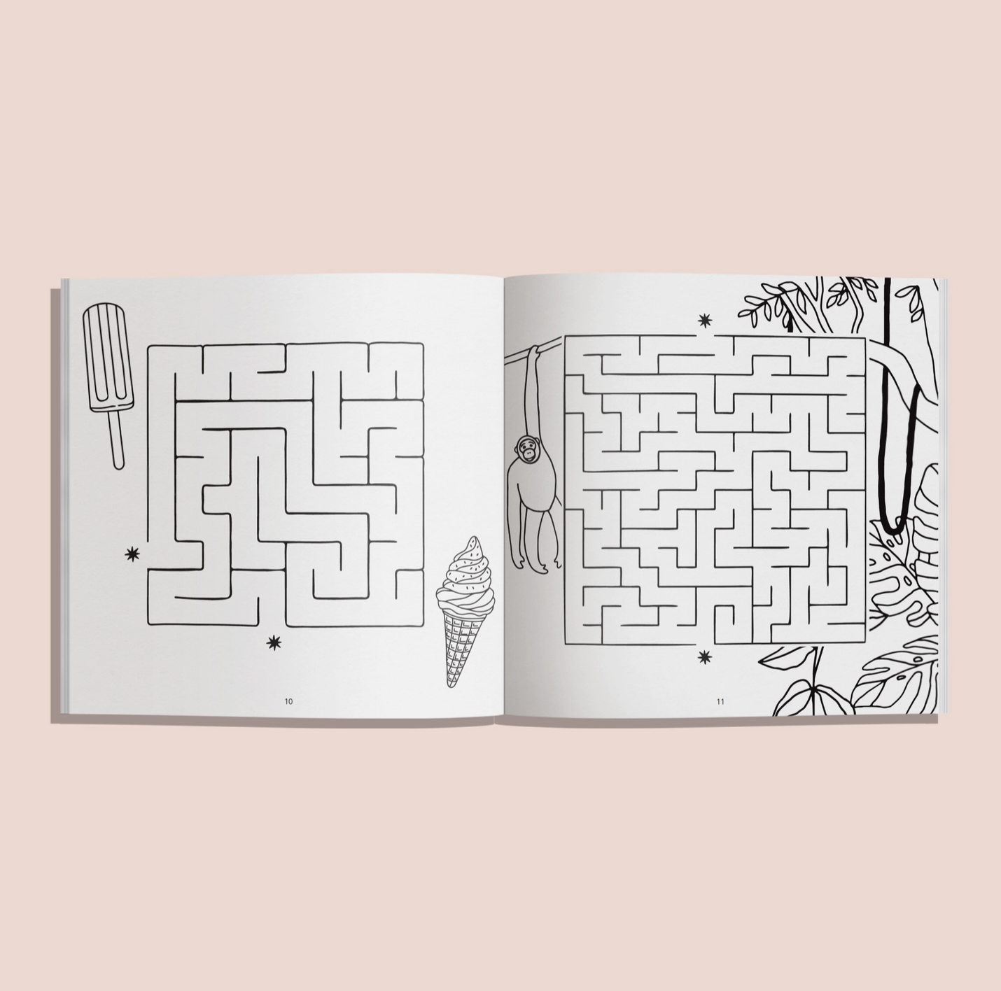 Open book with two maze illustrations on a light pink background