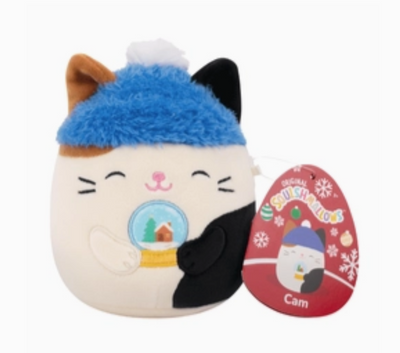 Plush toy resembling a cat with a blue hat and snow globe, next to its packaging on a white background.