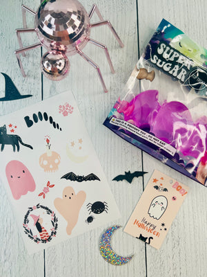 Halloween-themed stickers and decorations on a wooden surface