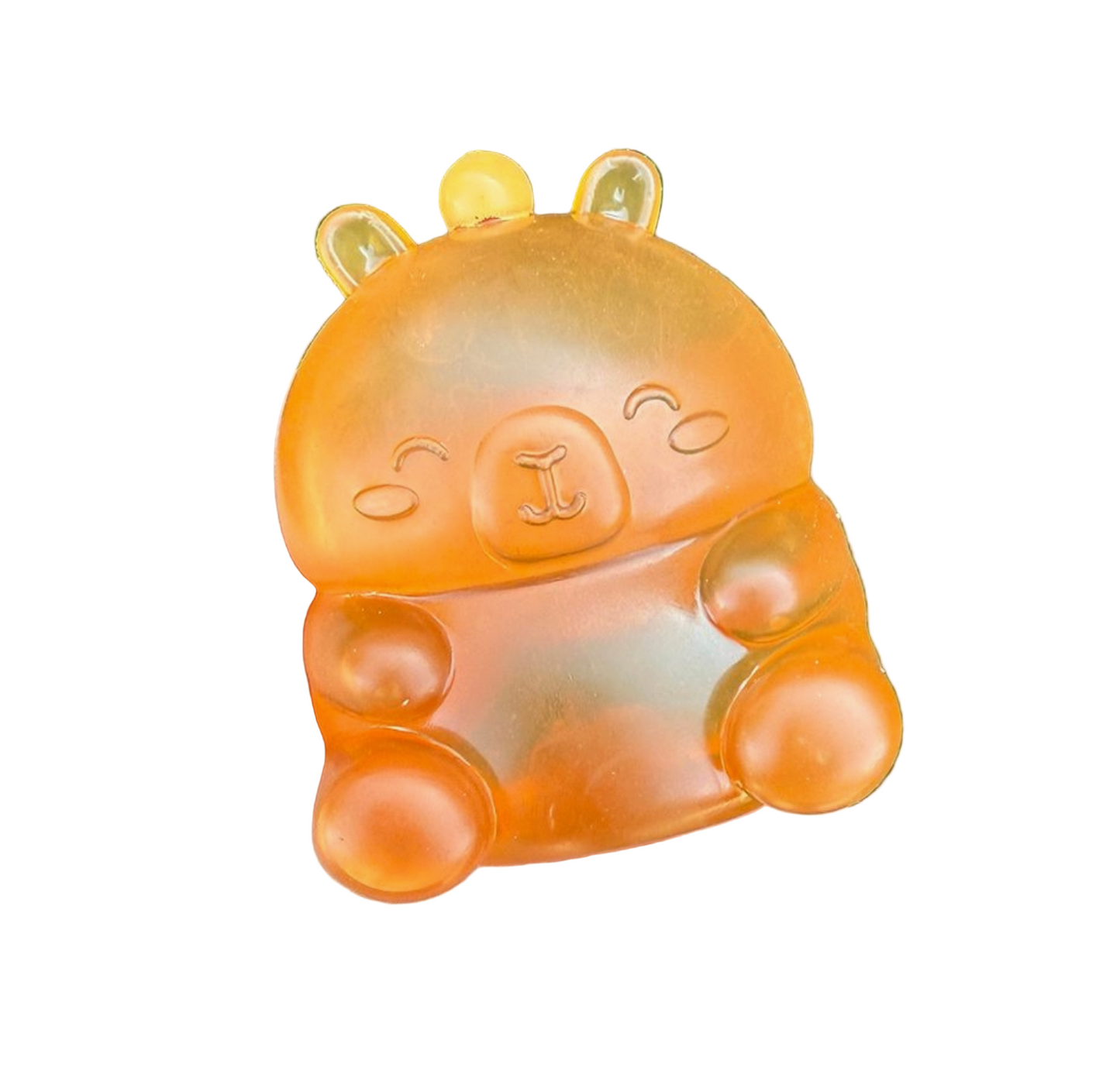 Orange animal-shaped toy held in a hand with grass background