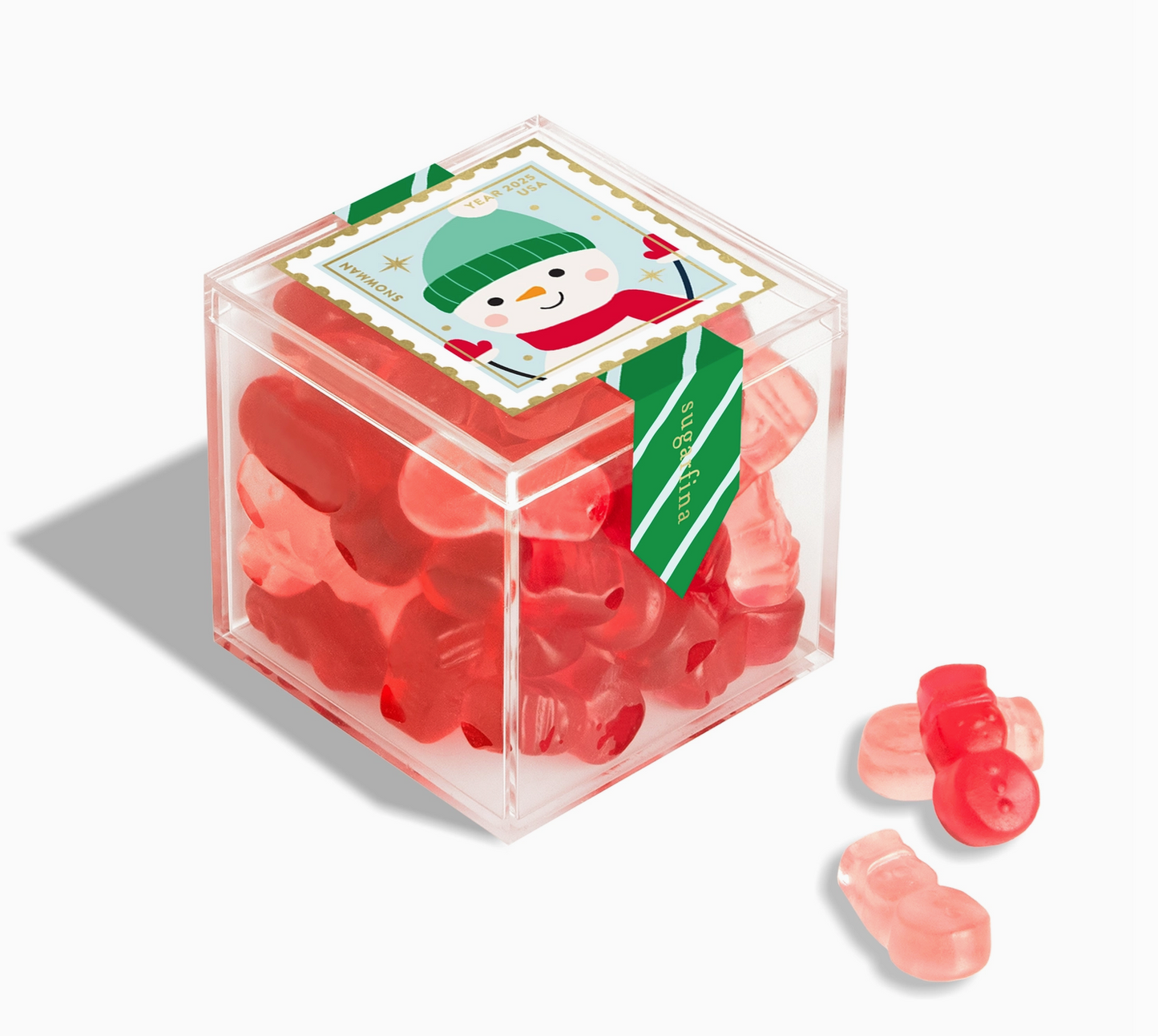 Clear cube container with red gummy bears and a snowman label on a white background
