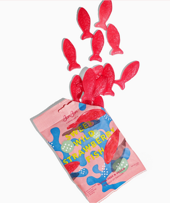 Red fish-shaped gummy candies with a pink packaging labeled 'Sweet Wild Strawberry Fish' on a white background.