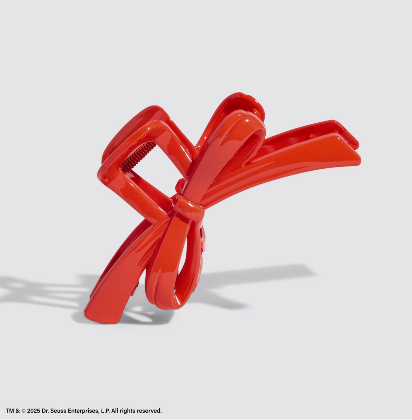 Red bow-shaped object on a white background