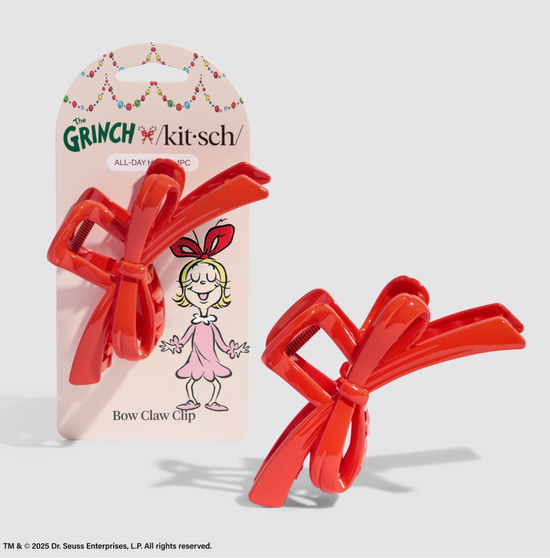 Red bow claw clip with packaging featuring a cartoon character on a light gray background
