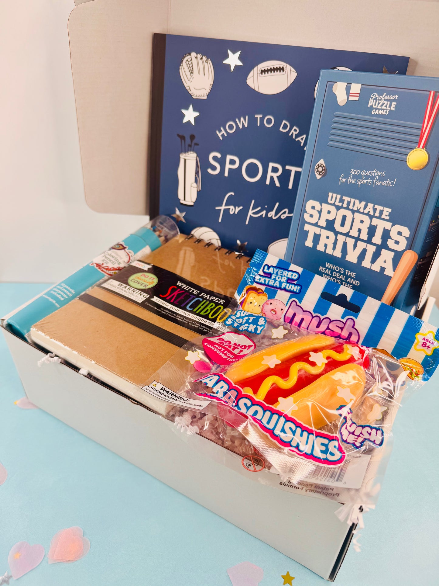 Educational and snack items including books and snacks on a light blue surface.