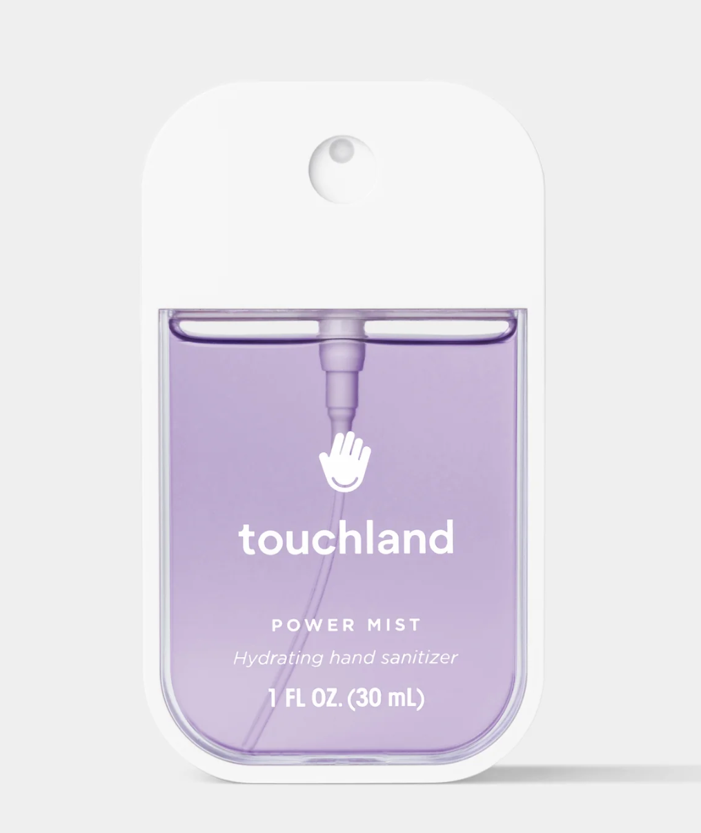 Purple hand sanitizer bottle with 'touchland' branding on a white background
