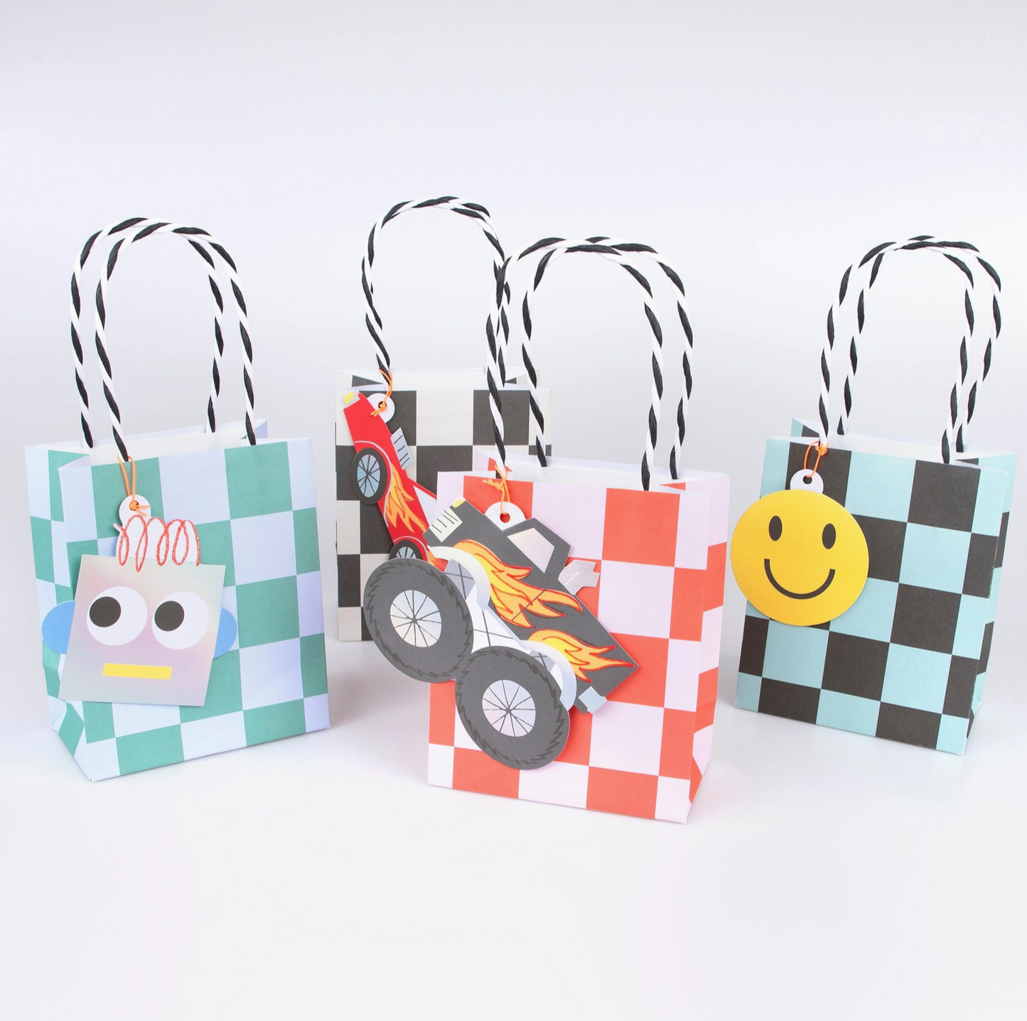 Three colorful paper bags with cartoon character tags on a white background