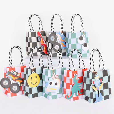 Set of colorful gift bags with cartoon character designs on a white background