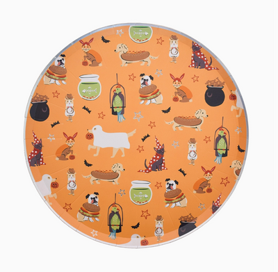 Round plate with Halloween-themed dog illustrations on an orange background