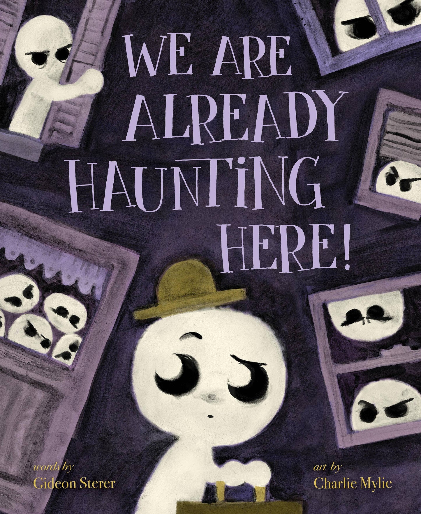 Children's book cover titled 'WE ARE ALREADY HAUNTING HERE!' with a stylized white ghost-like character wearing a brown hat at the bottom center, surrounded by dark purple house outlines and creepy faces peeking out from windows. Text at the bottom credits Gideon Sterer and Charlie Mylie.