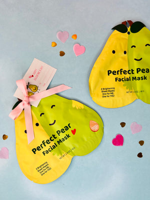 Two brightening facial masks designed to look like pears with 'Perfect Pair' text and decorated with pink ribbons and heart illustrations.