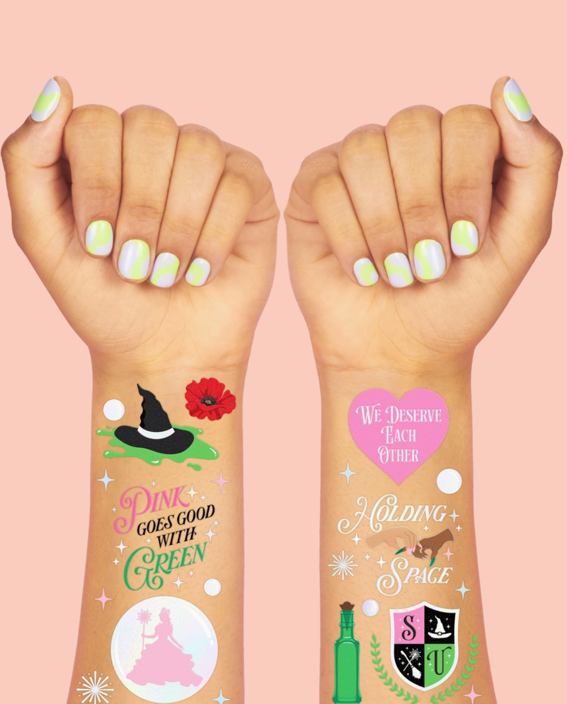 Two hands with colorful nail polish displaying various temporary tattoos on a pink background.