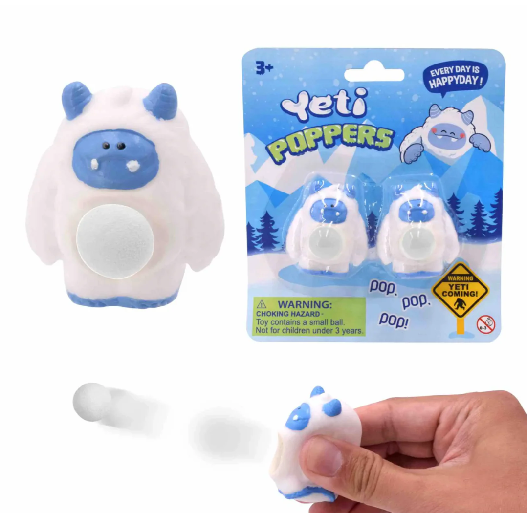 Yeti poppers toy with packaging and a hand holding one of the poppers.