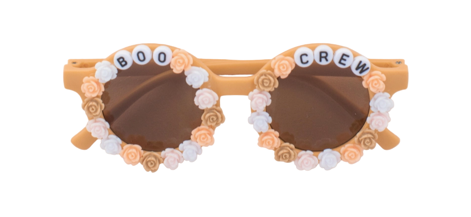 Heart-shaped sunglasses with floral embellishments and 'BOO CREW' text on a light background