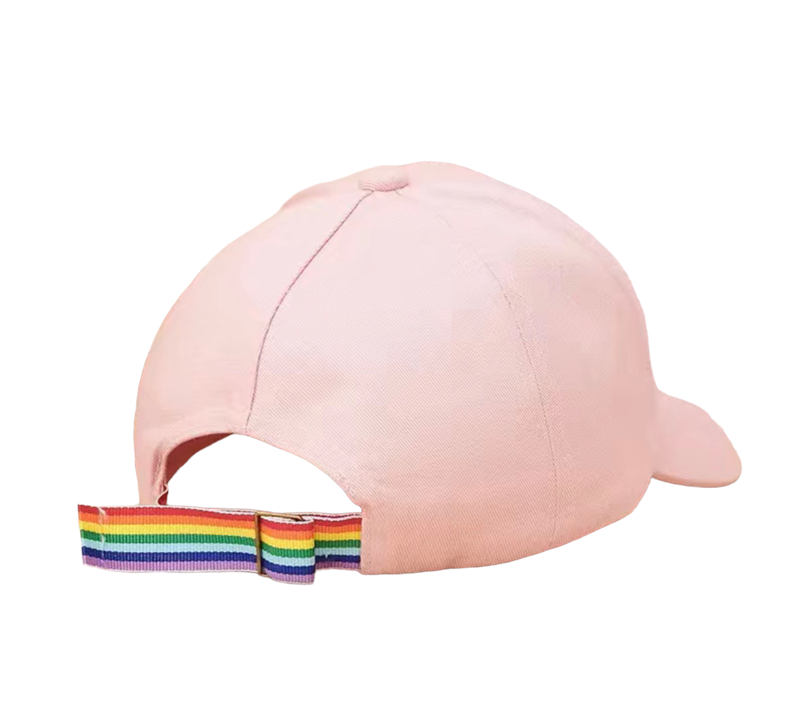 A light pink baseball cap with a rainbow-striped elastic back strap, shown from a side-back angle on a plain white background.