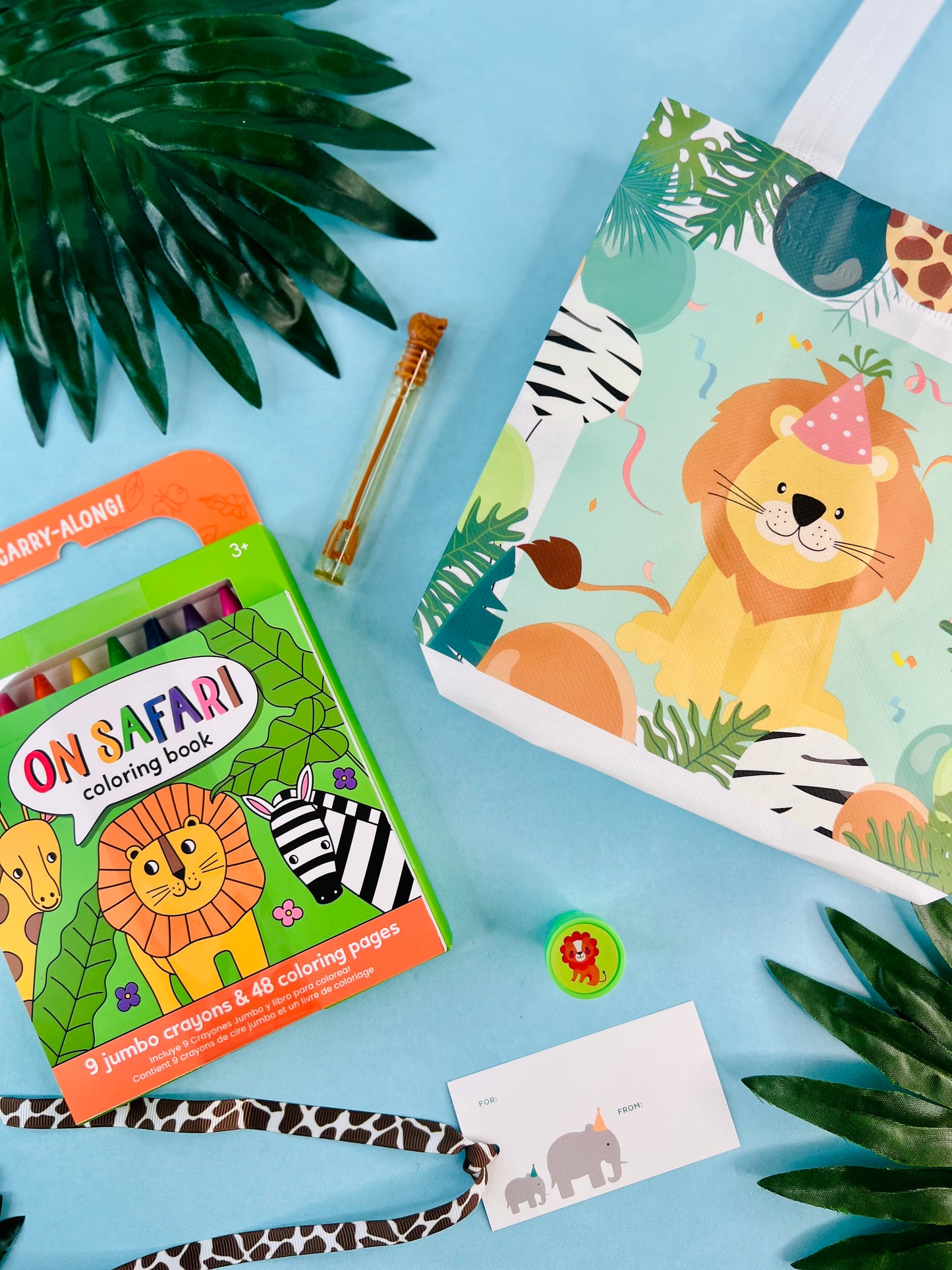 Coloring book party favor with a lion illustration on a blue background with leaves