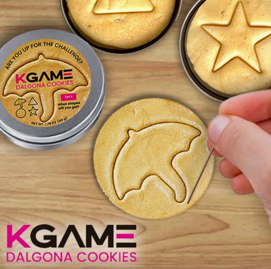 KGame Dalgona Cookies with cookie cutters on a wooden surface