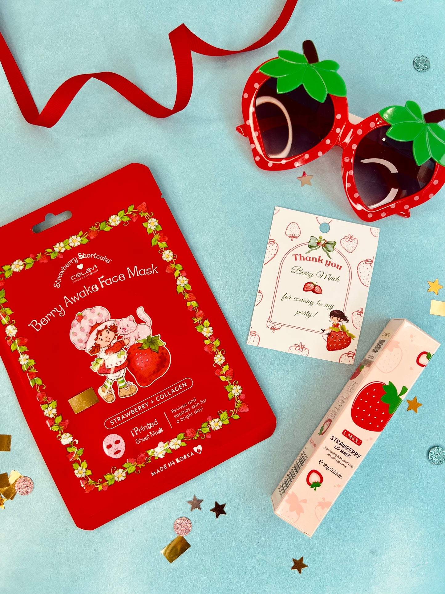 Berry-themed face mask packaging with strawberry design on a light blue background