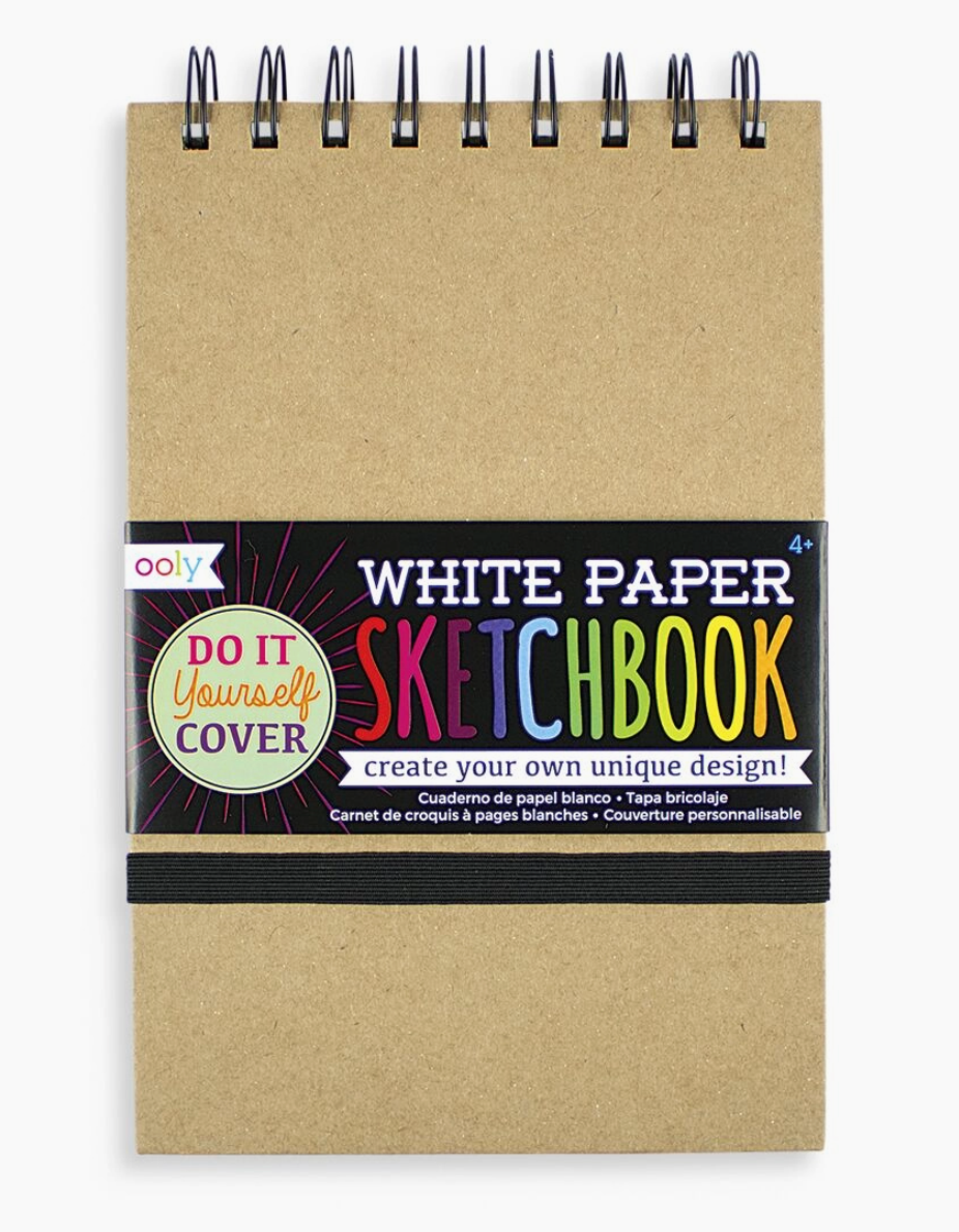A white paper sketchbook with a brown cover, labeled 'Ooly DIY Cover Sketchbook' and 'White Paper Sketchbook'.